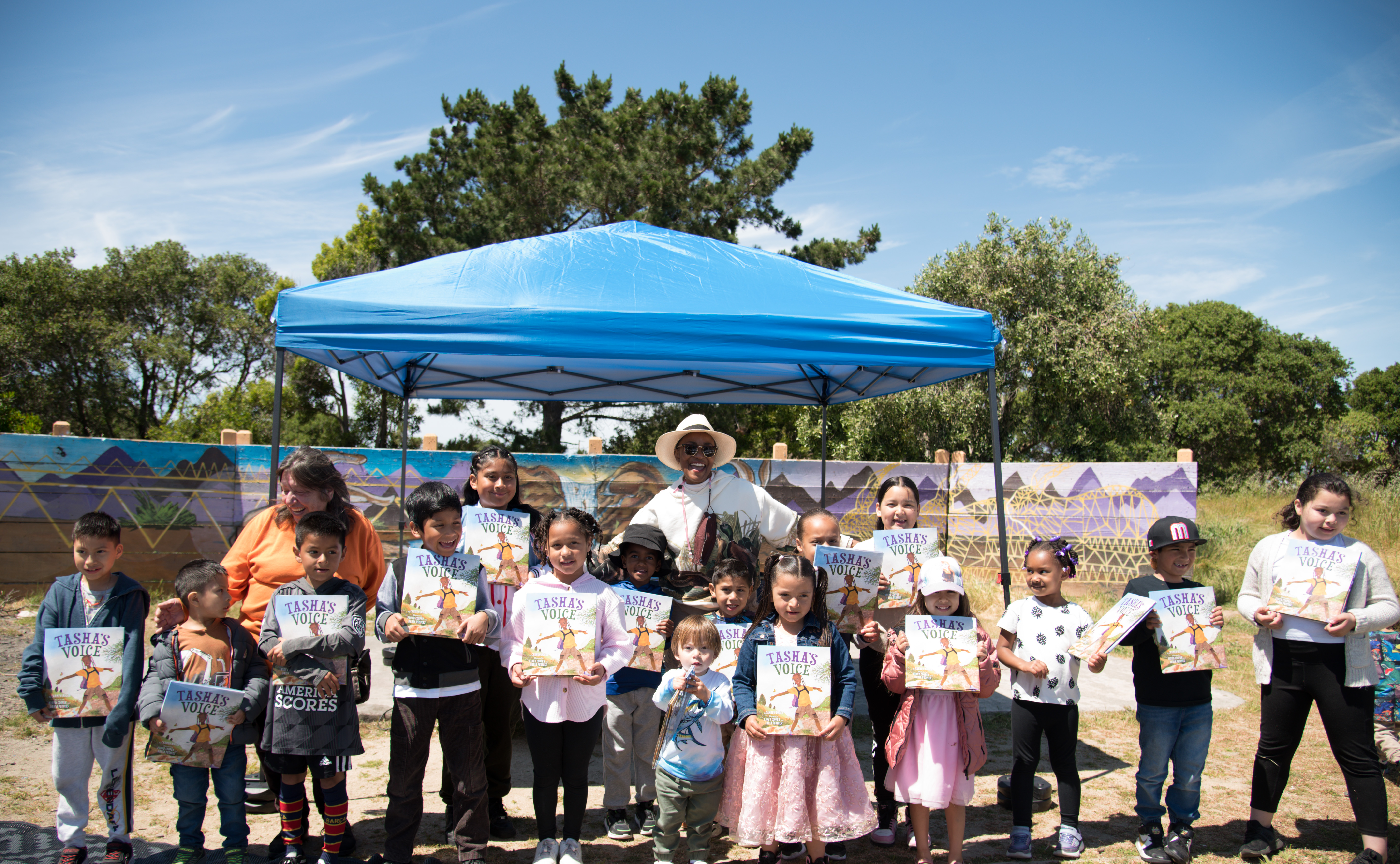 Author Carmen Bogen with children holding up her book